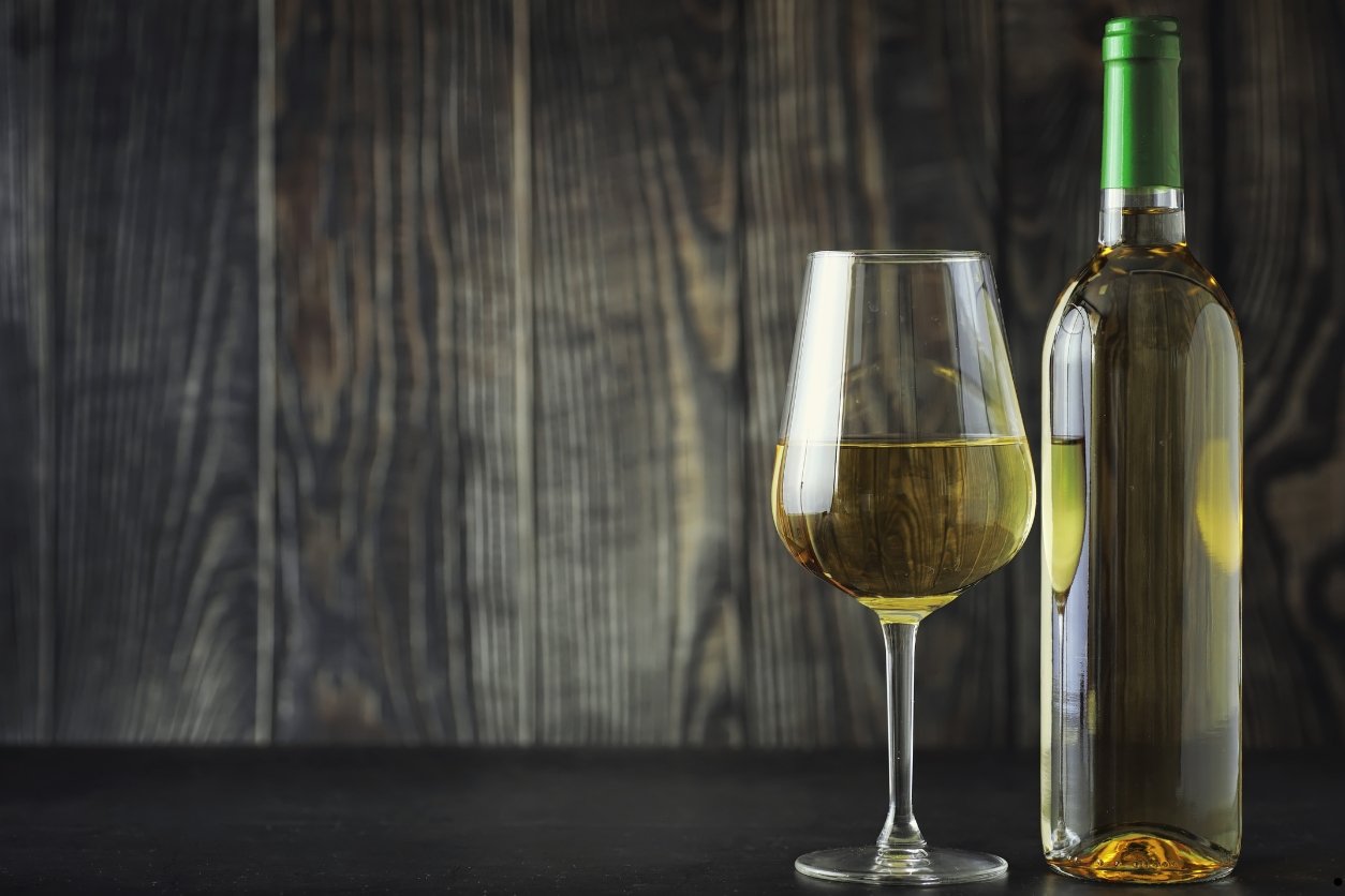 une bouteille de vin blanc sec avec un verre à vin